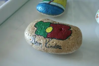 a rock with a flag on it sitting on a table at Albufeira Beach - Tranquilidade junto à praia e ao centro! in Albufeira