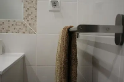 a bathroom with a towel hanging on the wall at Albufeira Beach - Tranquilidade junto à praia e ao centro! in Albufeira