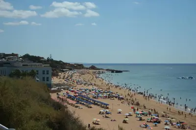 a crowd of people on a beach with the ocean at Albufeira Beach - Tranquilidade junto à praia e ao centro! in Albufeira