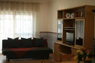 a living room with a couch and a tv at Albufeira Beach - Tranquilidade junto à praia e ao centro! in Albufeira