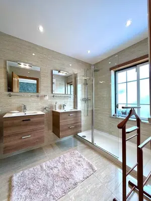 a large bathroom with two sinks and a shower at PARADISE ON THE BEACH in Albufeira