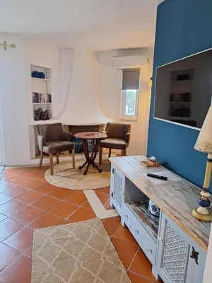 a living room with a table and a tv at Piece of Paradise @ Balaia Golf Village, Albufeira, PORTUGAL - 4 STAR in Albufeira