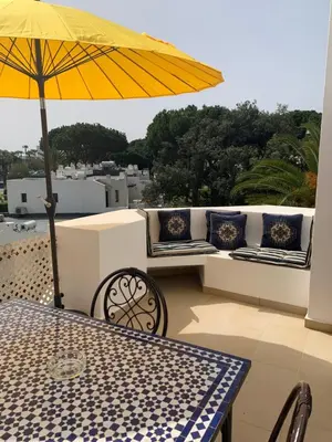 a table with a yellow umbrella on a patio at Piece of Paradise @ Balaia Golf Village, Albufeira, PORTUGAL - 4 STAR in Albufeira