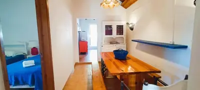 a kitchen with a wooden table in a room at Quinta do Lagar - 10 in Albufeira