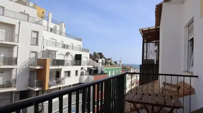 a balcony with two chairs and a view of buildings at MFA By Albufeira Rental in Albufeira