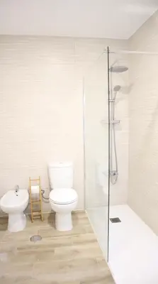 a bathroom with a toilet and a shower and a sink at MFA By Albufeira Rental in Albufeira