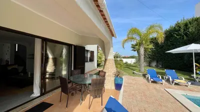 a patio with a table and chairs and a pool at Golfinho by Check-in Portugal in Albufeira