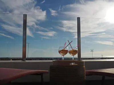 two wine glasses sitting on a table in front of a window at Charming V2 next to ocean, golf & natural reserve in Albufeira