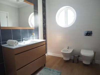 a bathroom with a sink and a toilet and a window at Charming V2 next to ocean, golf & natural reserve in Albufeira