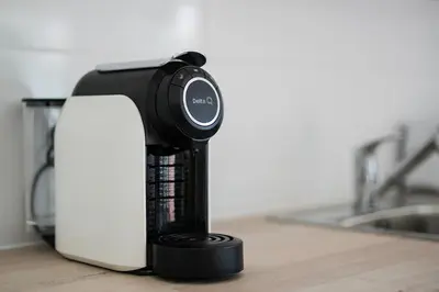a black coffee machine sitting on a kitchen counter at Sunny Albufeira - 5min to the beach by LovelyStay in Albufeira