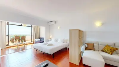 a hotel room with a bed and a couch at Apartamento CPiscina-Albufeira in Albufeira