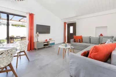 a living room with a couch and a table at Villa Petala in Albufeira