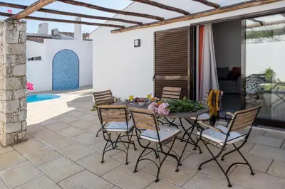 a bedroom with two yellow beds and a mirror at Villa Petala in Albufeira