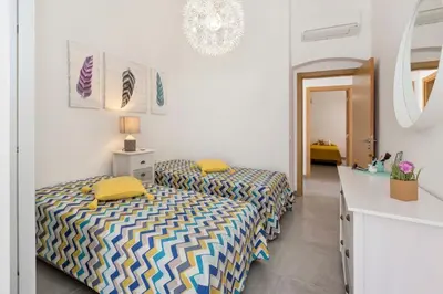 a white bathroom with a tub and a sink at Villa Petala in Albufeira