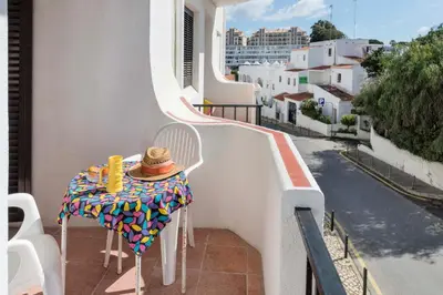 a table with a hat sitting on top of a balcony at Apartment Maresia in Albufeira