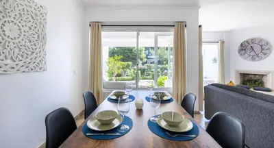 a dining room with a table and a couch at LongLands Peak at Windmill Hill in Albufeira