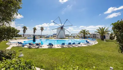 a windmill next to a swimming pool with a windmill at LongLands Peak at Windmill Hill in Albufeira