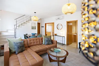 a living room with a couch and a table at Pink House in Faro