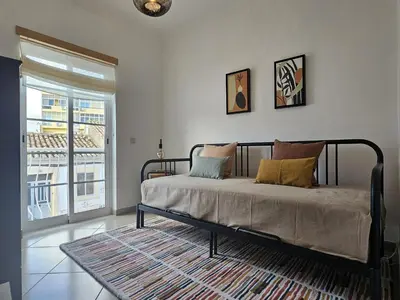a bedroom with a bed with pillows on it at Pink House in Faro