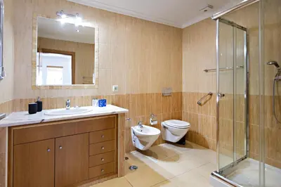a bathroom with a toilet and a sink and a shower at Pink House in Faro