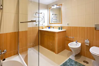 a bathroom with a sink and a toilet and a shower at Pink House in Faro