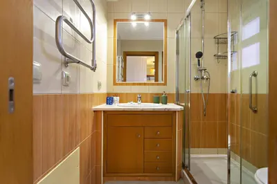a bathroom with a sink and a shower and a mirror at Pink House in Faro