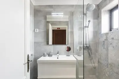 a bathroom with a white sink and a shower at Scandic - City Center by HD Properties in Vilamoura