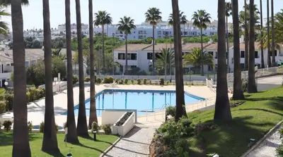 an overhead view of a pool with palm trees at Vila Alba by Albufeira Rental in Albufeira