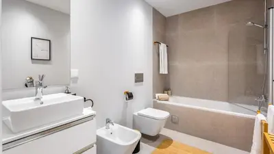 a bathroom with a sink and a toilet and a tub at Dream Apartment W/Pool & Balcony by LovelyStay in Albufeira