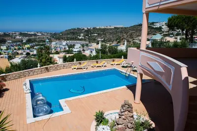 a swimming pool on the roof of a house at Villa Malu in Albufeira