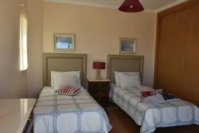 a bedroom with two beds and a table with a lamp at Villa Malu in Albufeira