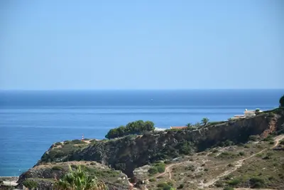 a view of the ocean from atop a cliff at Villa Malu in Albufeira
