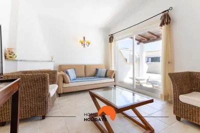a living room with a couch and a glass table at #133 Vila Dias 1 by Home Holidays in Albufeira