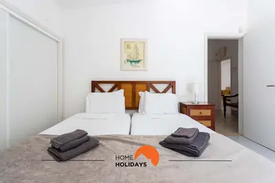 two beds in a bedroom with two towels on the bed at #133 Vila Dias 1 by Home Holidays in Albufeira