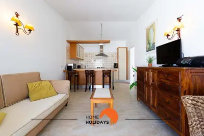 a living room with a couch and a tv and a kitchen at #134 Vila Dias 2 by Home Holidays in Albufeira