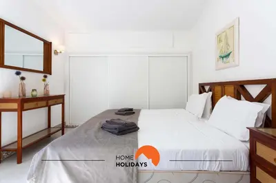 a bedroom with a large white bed with a mirror at #134 Vila Dias 2 by Home Holidays in Albufeira