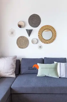a living room with a blue couch and a white wall at #114 T2 Foxy H by Home Holidays in Albufeira