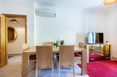 a dining room with a table and chairs at Jacaranda in Albufeira