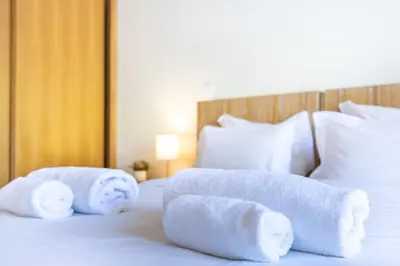a hotel room with two towels on a bed at Jacaranda in Albufeira