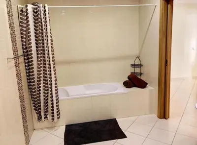 a bath tub in a bathroom with a shower at Candyland Apartment in Albufeira