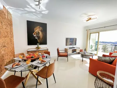 a living room with a view of a balcony at Luxury Condo in Top Complex with Ocean and Marina View by Be Cherish in Albufeira