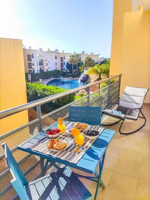 a table with a tray of food on a balcony at Luxury Condo in Top Complex with Ocean and Marina View by Be Cherish in Albufeira