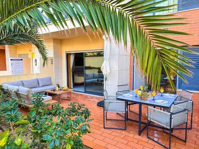 a patio with a table and chairs and a couch at Luxury Corcovada by BeCherish in Albufeira