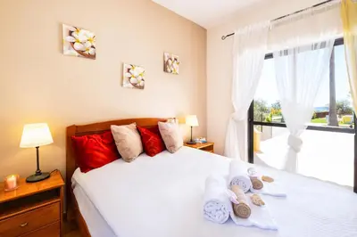 a bedroom with a bed and a large window at Villa Oasis Del Mar by Algarve Vacation in Albufeira