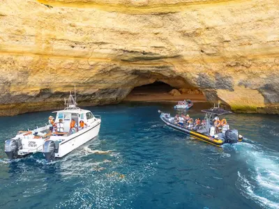 two boats in the water next to a cave at Villa Oasis Del Mar by Algarve Vacation in Albufeira
