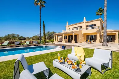 a villa with a swimming pool and a house at Villa Oasis Del Mar by Algarve Vacation in Albufeira