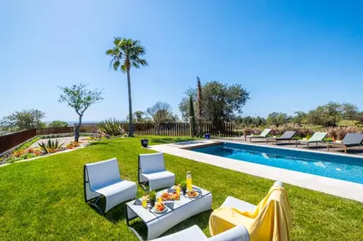 a backyard with a pool with chairs and a table at Villa Oasis Del Mar by Algarve Vacation in Albufeira