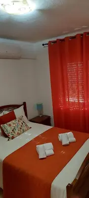 a bedroom with a bed with two towels on it at Appart Oura Strip in Albufeira