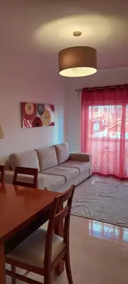 a living room with a couch and a table at Appart Oura Strip in Albufeira