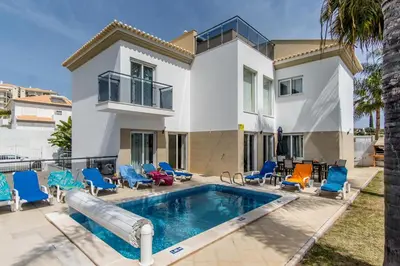 a villa with a swimming pool and a house at Villa Casa Vilas Boas in Albufeira